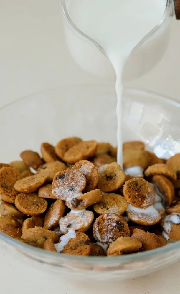 Milk poured over Chocolate Chip Cereal Cookies